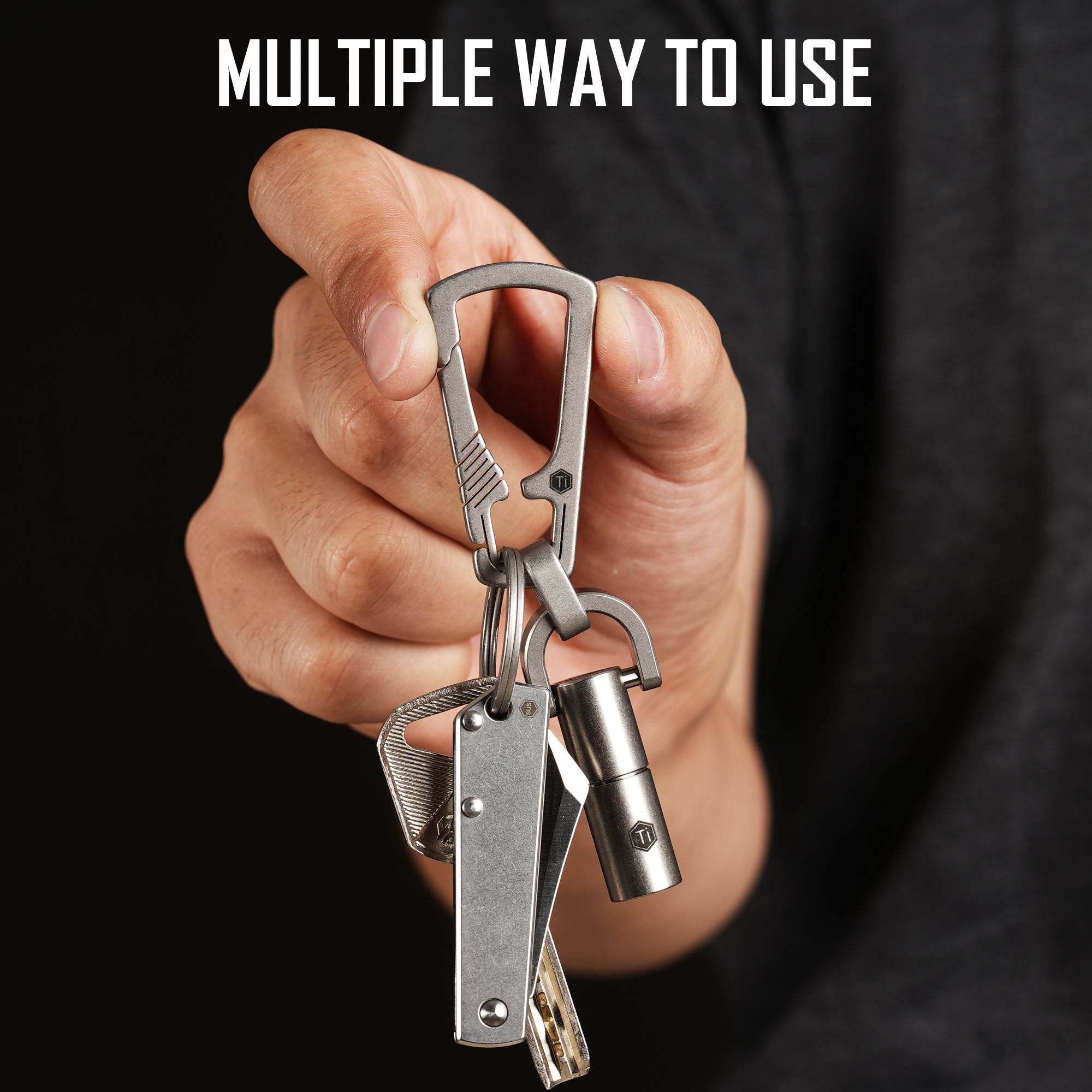KM16 carabiner clip holding EDC items in a hand