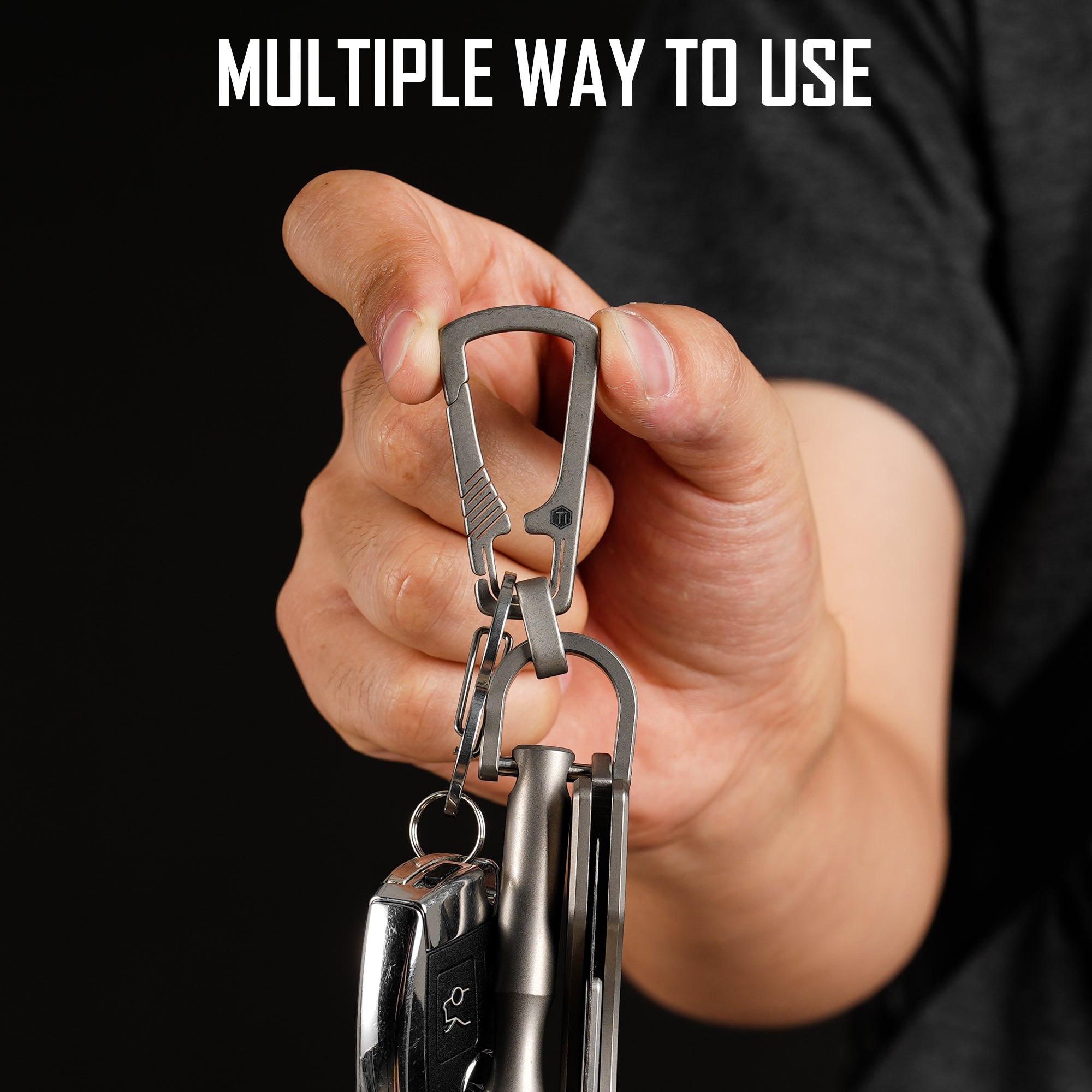 KM17 carabiner clip holding EDC items in a hand