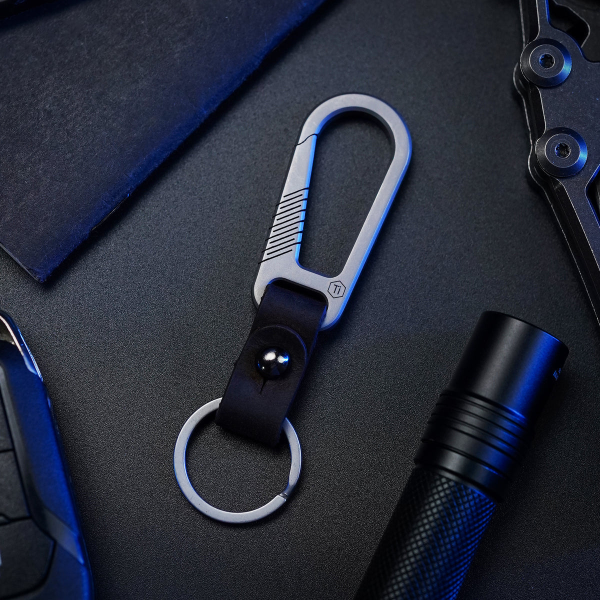 titanium carabiner keychain displayed with everyday carry gear